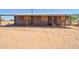 Shows an exterior view of the house, featuring a covered awning along the front and a spacious yard at 43384 W Padilla Rd, Maricopa, AZ 85138