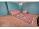Spacious living area with comfortable seating and a colorful rug, ideal for relaxing or entertaining guests at 43384 W Padilla Rd, Maricopa, AZ 85138