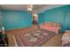 Cozy living room featuring teal walls, plush seating, and a decorative rug, offering a warm and inviting space at 43384 W Padilla Rd, Maricopa, AZ 85138