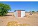 Exterior shot of a metal storage shed, offering ample space for tools and equipment at 43384 W Padilla Rd, Maricopa, AZ 85138