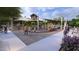 Community playground with shade sails and a large climbing structure and slides at 46484 W Lander Ln, Maricopa, AZ 85139