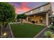 Beautiful backyard featuring lush green grass, a covered patio, and ample space for outdoor activities at 5123 S Mariposa Dr, Gilbert, AZ 85298