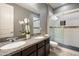 Modern bathroom featuring double sinks, a glass-enclosed shower, and stylish neutral tones at 5123 S Mariposa Dr, Gilbert, AZ 85298