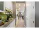 Hallway with white cabinets and granite countertops leads to modern kitchen with stainless steel appliances and outdoor views at 5123 S Mariposa Dr, Gilbert, AZ 85298