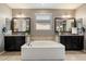Serene main bathroom with a luxurious soaking tub, double vanities, and elegant fixtures at 5123 S Mariposa Dr, Gilbert, AZ 85298