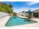 Private pool with a travertine deck is surrounded by mature trees and lush landscaping, creating a tranquil retreat at 5438 E Lupine Ave, Scottsdale, AZ 85254