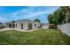 Spacious backyard with lush lawn, stucco walls, and mature landscaping at 5438 E Lupine Ave, Scottsdale, AZ 85254