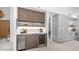 Modern bar with wine fridge, beverage center, and elegant cabinetry that flows into the kitchen at 5438 E Lupine Ave, Scottsdale, AZ 85254