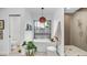 Charming bathroom with soaking tub under a window, decorative pendant light, and glass shower at 5438 E Lupine Ave, Scottsdale, AZ 85254