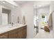 Contemporary bathroom with quartz counters, glass shower, and backyard access at 5438 E Lupine Ave, Scottsdale, AZ 85254