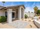 Charming front exterior with covered entry, decorative pillars, desert landscaping, and stone tiles at 5438 E Lupine Ave, Scottsdale, AZ 85254
