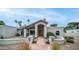 Inviting front exterior with stone pathway, decorative pillars, desert landscaping, and stylish entryway at 5438 E Lupine Ave, Scottsdale, AZ 85254