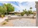 Paver patio overlooking front yard with desert landscaping, mature trees, and charming facade at 5438 E Lupine Ave, Scottsdale, AZ 85254