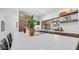 Modern kitchen showcasing quartz countertops, a center island with cooktop, and stylish wooden cabinets at 5438 E Lupine Ave, Scottsdale, AZ 85254