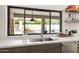 Kitchen with a sink overlooking a backyard pool and outdoor lounge area, with a large window at 5438 E Lupine Ave, Scottsdale, AZ 85254
