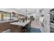 Open kitchen features a central island with seating, modern appliances, and flows to outdoor spaces at 5438 E Lupine Ave, Scottsdale, AZ 85254