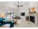 Bright living room featuring a fireplace, modern furniture, and arched window at 5438 E Lupine Ave, Scottsdale, AZ 85254