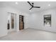 Bright main bedroom with white walls, ceiling fan, closet, tile floor and access to the main bath at 5438 E Lupine Ave, Scottsdale, AZ 85254