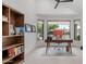 Bright home office featuring a large desk, bookcase, and multiple windows at 5438 E Lupine Ave, Scottsdale, AZ 85254