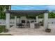 Outdoor kitchen with a grill, bar seating, fireplace, pergola, and backyard at 5438 E Lupine Ave, Scottsdale, AZ 85254
