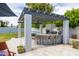 Outdoor kitchen features a grill, bar seating, pergola, and landscaped backyard at 5438 E Lupine Ave, Scottsdale, AZ 85254