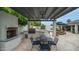 Outdoor kitchen with bar seating, fireplace, and lounge area overlooking the backyard pool at 5438 E Lupine Ave, Scottsdale, AZ 85254