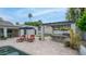 Outdoor patio with travertine tile, lounge chairs, umbrellas, and outdoor kitchen with seating at 5438 E Lupine Ave, Scottsdale, AZ 85254