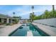 Inviting backyard pool with lounge chairs, umbrellas, and outdoor kitchen under blue skies at 5438 E Lupine Ave, Scottsdale, AZ 85254