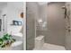 Beautiful glass-enclosed shower with rain shower head, hand shower, and tiled bench at 5438 E Lupine Ave, Scottsdale, AZ 85254