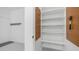 Garage storage area with painted walls, pegboard, and white shelving at 5438 E Lupine Ave, Scottsdale, AZ 85254