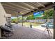 Inviting covered patio with ceiling fan, outdoor seating, and entertainment area overlooking the backyard at 5926 E Hartford Ave, Scottsdale, AZ 85254