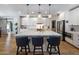 Charming kitchen featuring a large center island, stainless appliances, and white cabinetry at 5926 E Hartford Ave, Scottsdale, AZ 85254