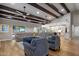 Open-concept living area boasts hardwood floors, beamed ceilings, and seamlessly connects to the kitchen at 5926 E Hartford Ave, Scottsdale, AZ 85254