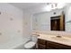 Bathroom featuring a combined tub and shower and vanity with light tan countertop at 6 E Manzanita Dr, Phoenix, AZ 85020