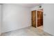 Bedroom featuring wall-to-wall carpet and a closet with dark wood sliding doors at 6 E Manzanita Dr, Phoenix, AZ 85020