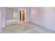 Neutral living room with wall-to-wall carpet, a mirrored closet, and an open doorway to the adjacent room at 6 E Manzanita Dr, Phoenix, AZ 85020