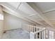 Loft view of the white beam ceiling with carpet and wood railing at 6 E Manzanita Dr, Phoenix, AZ 85020