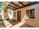 Enclosed patio area with a partial pergola, accent wall, and secure door at 6 E Manzanita Dr, Phoenix, AZ 85020