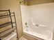 This bathroom offers a tub/shower combination with minimalist shelving at 603 S Allred Dr, Tempe, AZ 85281
