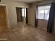 Bright bedroom with tiled flooring, large closet with sliding mirror doors, and window with curtains at 603 S Allred Dr, Tempe, AZ 85281