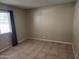 Bedroom featuring neutral wall color, tiled flooring, and a window for natural light at 603 S Allred Dr, Tempe, AZ 85281