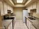 Galley-style kitchen offers modern appliances, granite countertops, and tile flooring at 603 S Allred Dr, Tempe, AZ 85281