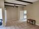 Bright living room featuring exposed beams, tile flooring, and neutral wall color at 603 S Allred Dr, Tempe, AZ 85281