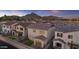 Aerial view of a suburban home surrounded by other houses and featuring mountain views in the distance at 6434 N 17Th St, Phoenix, AZ 85016