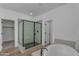 Bathroom featuring a glass shower door and a modern standalone soaking tub at 6434 N 17Th St, Phoenix, AZ 85016