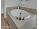 Bathroom featuring a tiled standalone soaking tub with modern fixtures at 6434 N 17Th St, Phoenix, AZ 85016