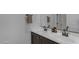 Modern bathroom with a double sink vanity, sleek dark brown cabinets, and towel racks at 6434 N 17Th St, Phoenix, AZ 85016