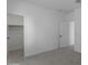 This bedroom has neutral carpeting, white walls, and features an adjacent walk-in closet at 6434 N 17Th St, Phoenix, AZ 85016