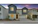 Two-story home featuring a two-car garage, neutral stucco, grey siding, and a well-manicured front yard at 6434 N 17Th St, Phoenix, AZ 85016