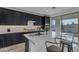 Gourmet kitchen with quartz island, stainless appliances, and modern black cabinetry at 6434 N 17Th St, Phoenix, AZ 85016